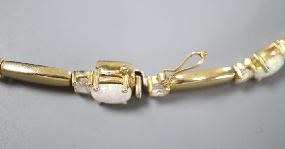 A pair of 585, white opal and paste stud earrings and a similar paste-set bracelet and ring ensuite, gross 21.6g.